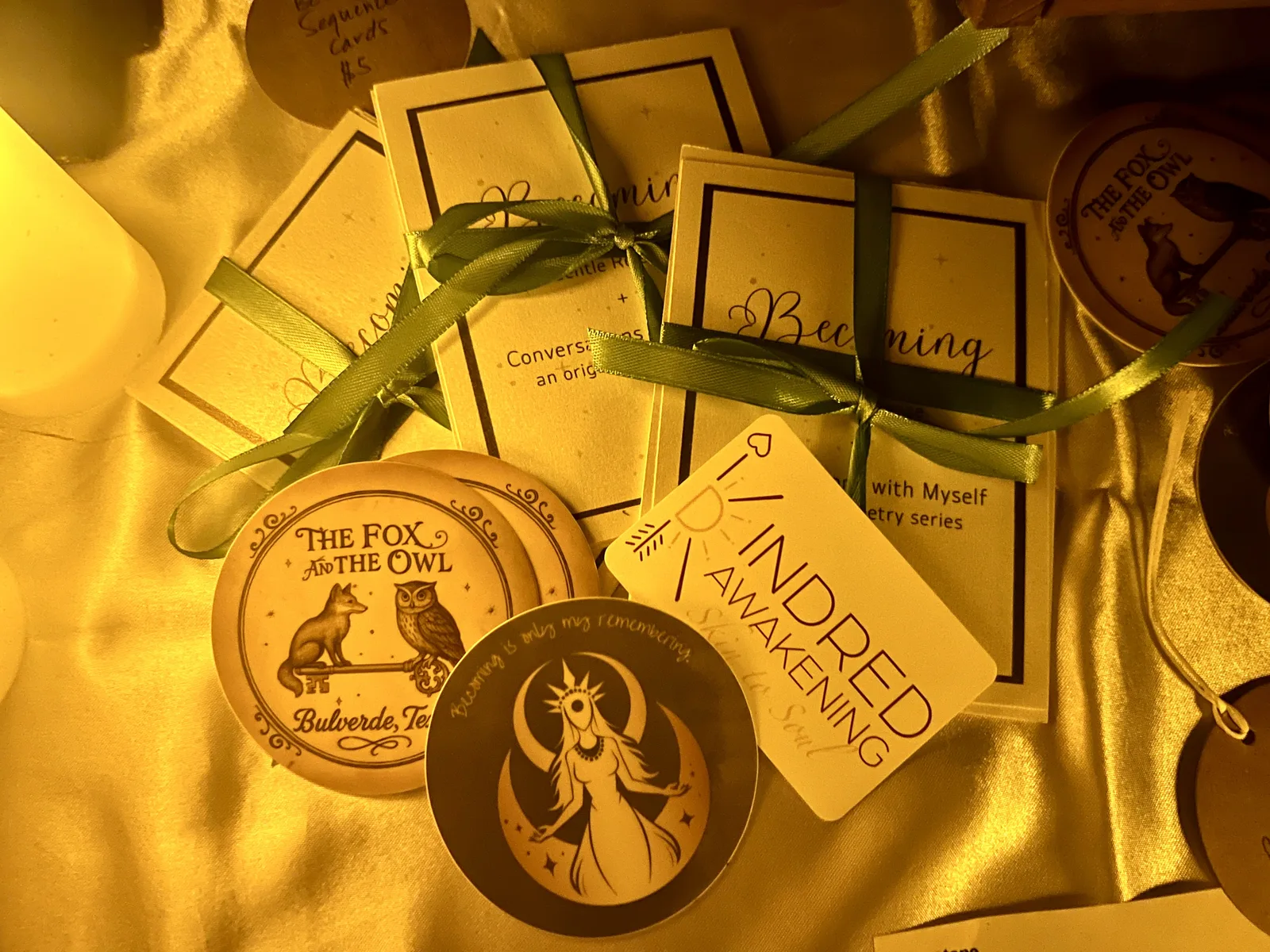 Favor bags on gold cloth with ribbon-tied cards from The Fox & The Owl and Kindred Awakening